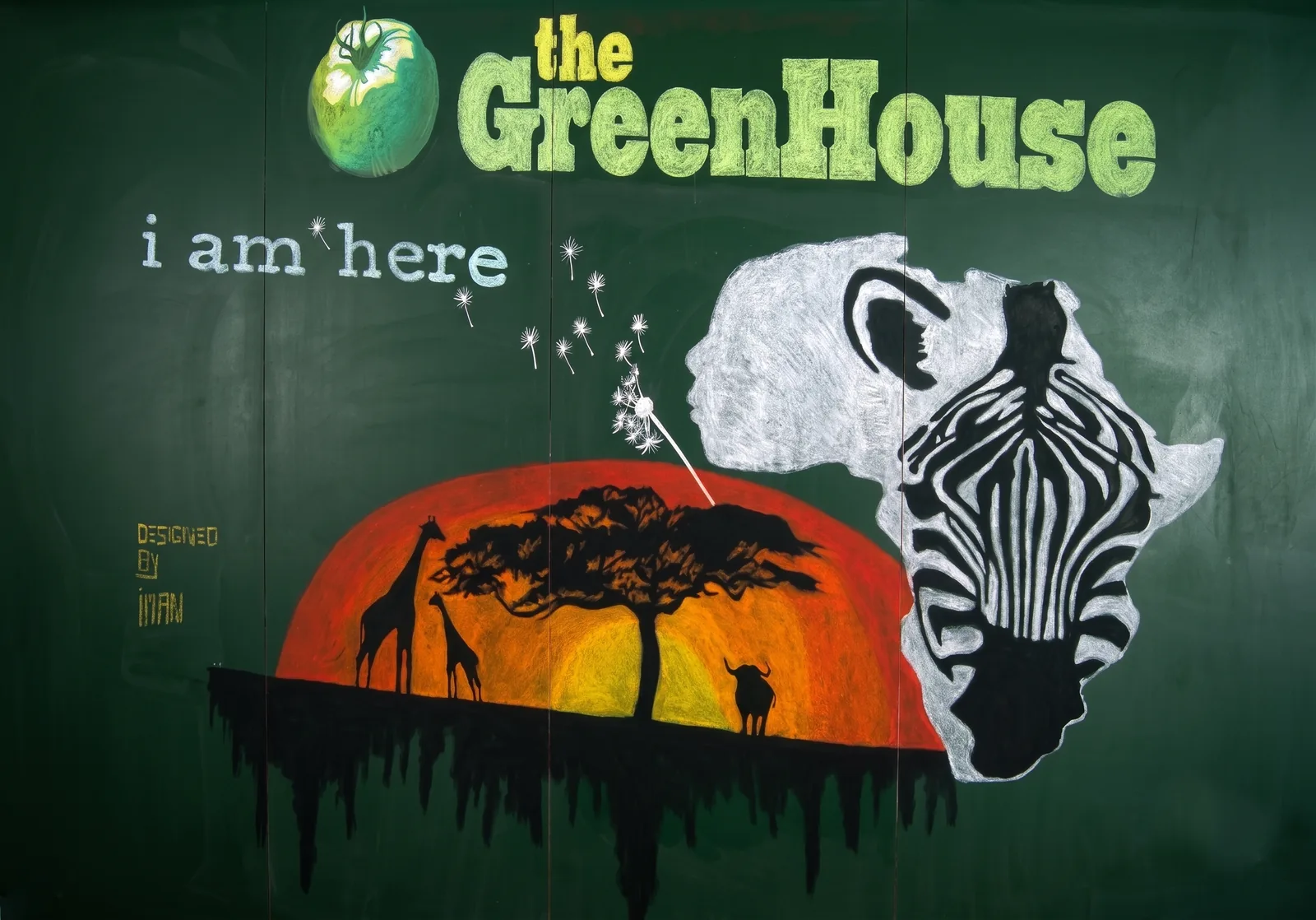 Hand-drawn chalk wall mural for I Am Here theatre show entrance — African landscape imagery and chalk typography.