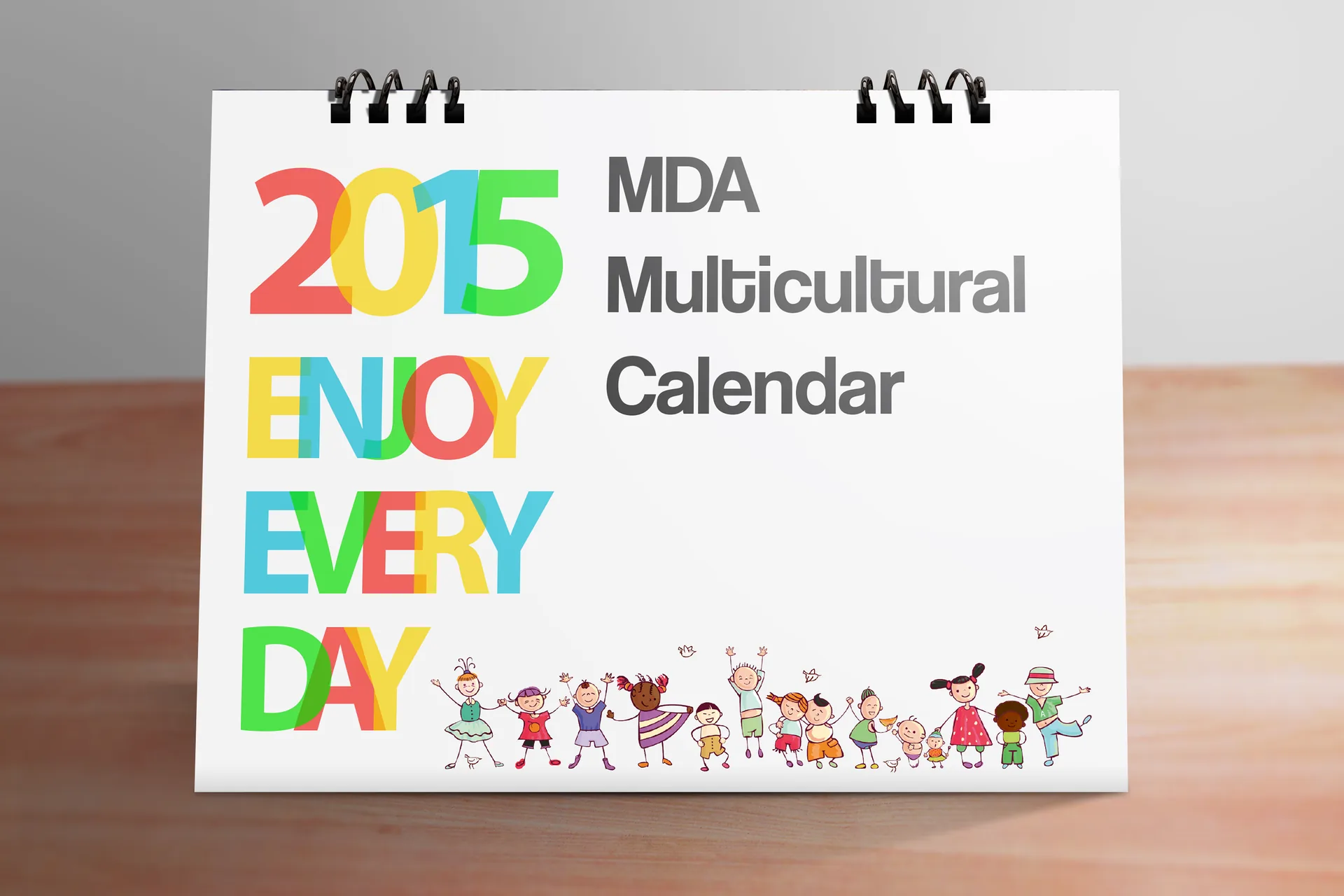 MDA 2015 Multicultural Calendar — colourful illustrated desk calendar cover featuring multicultural character artwork.