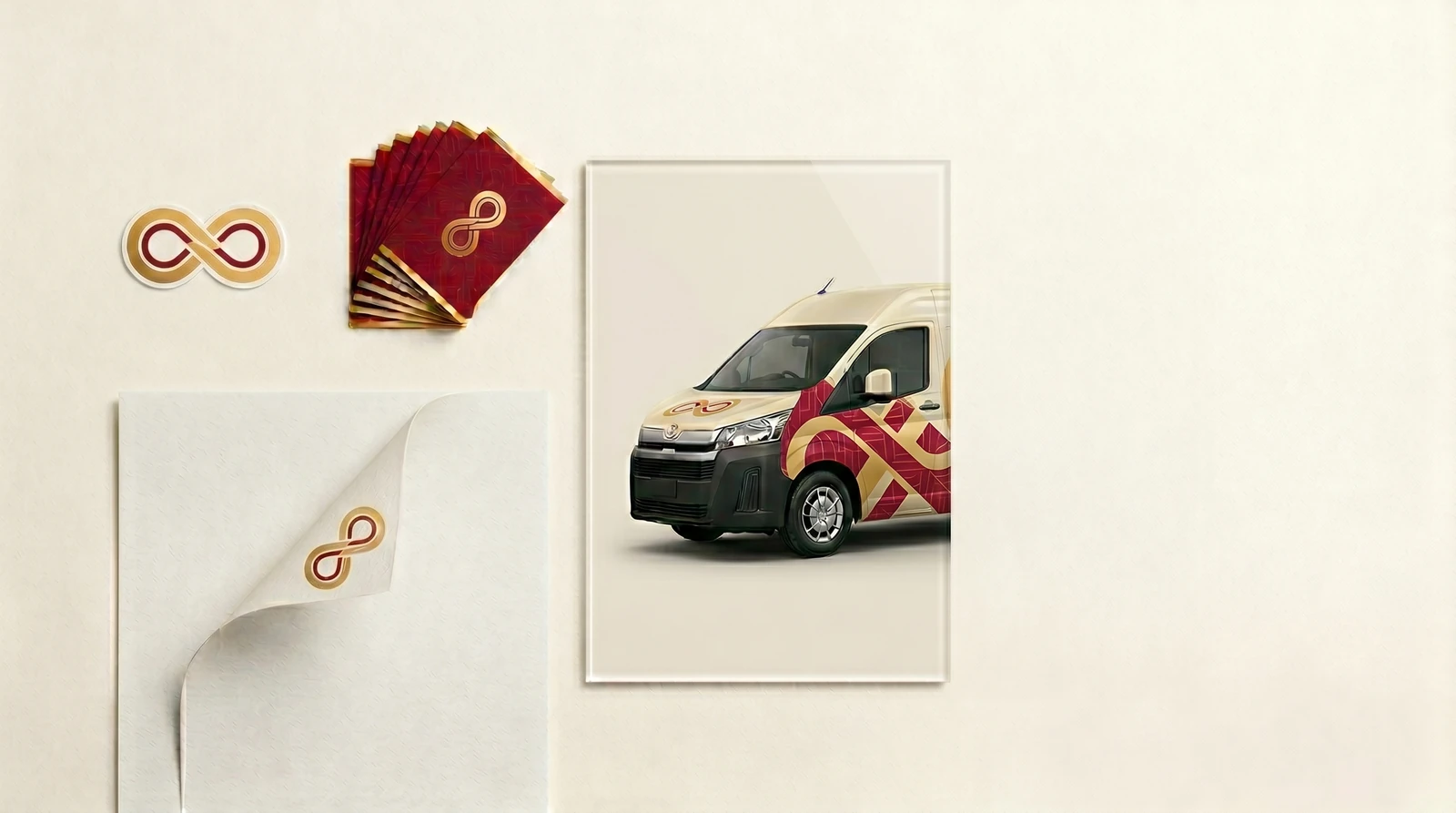 Brand collateral mockup: a logo mark, business cards, letterhead and a wrapped van in deep red and gold.
